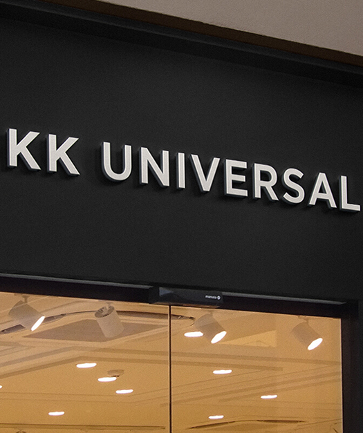 KK UNIVERSAL storefront sign in white letters above a glass entrance.