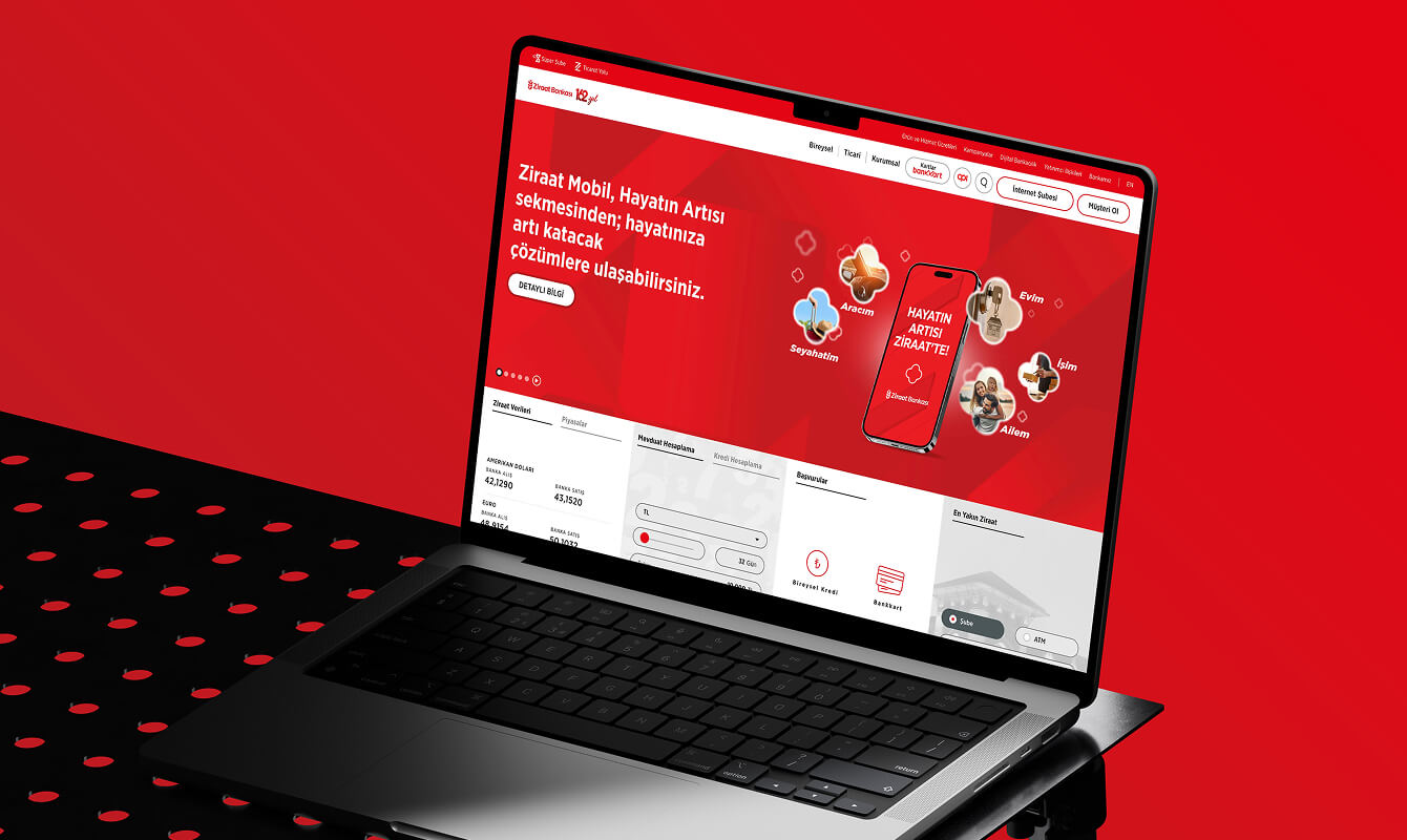 Gray laptop on red background displaying the Ziraat Bankası homepage.
